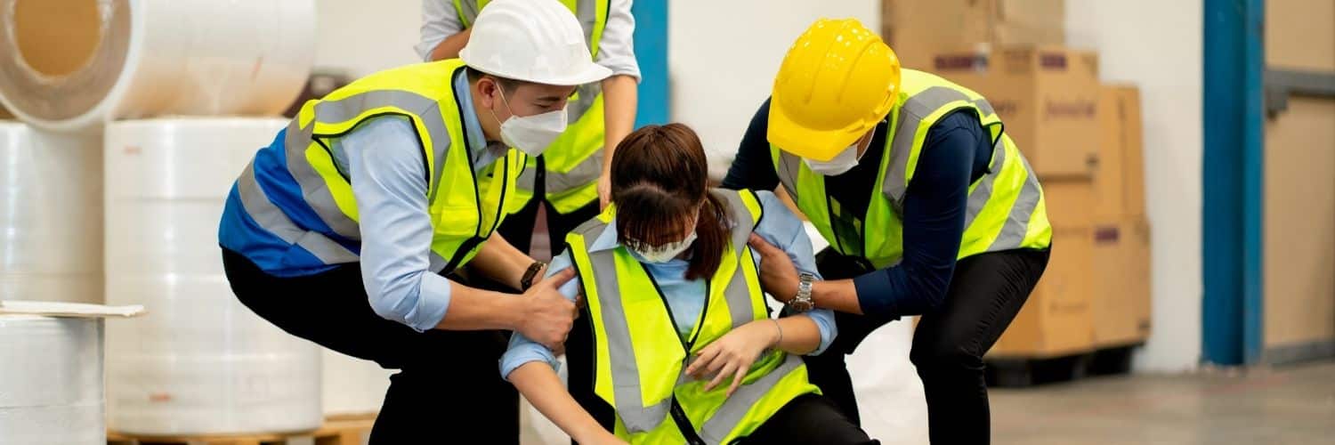 two workers helping a woman