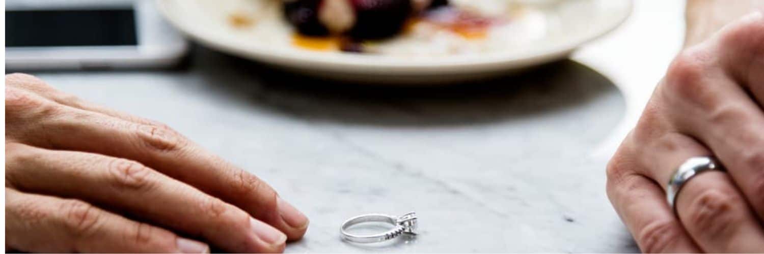 couple hands with wedding ring on the table