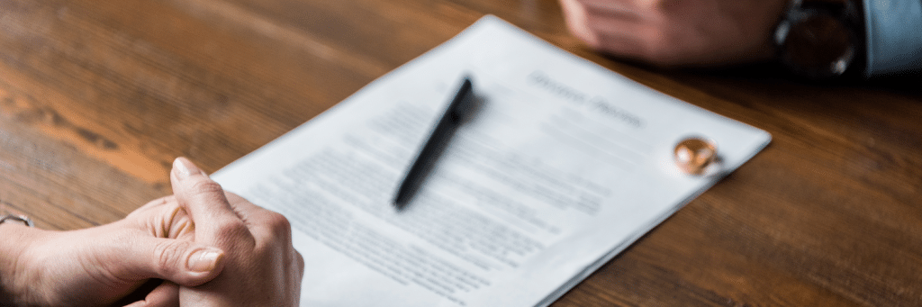 two adults and signing divorce application paperwork