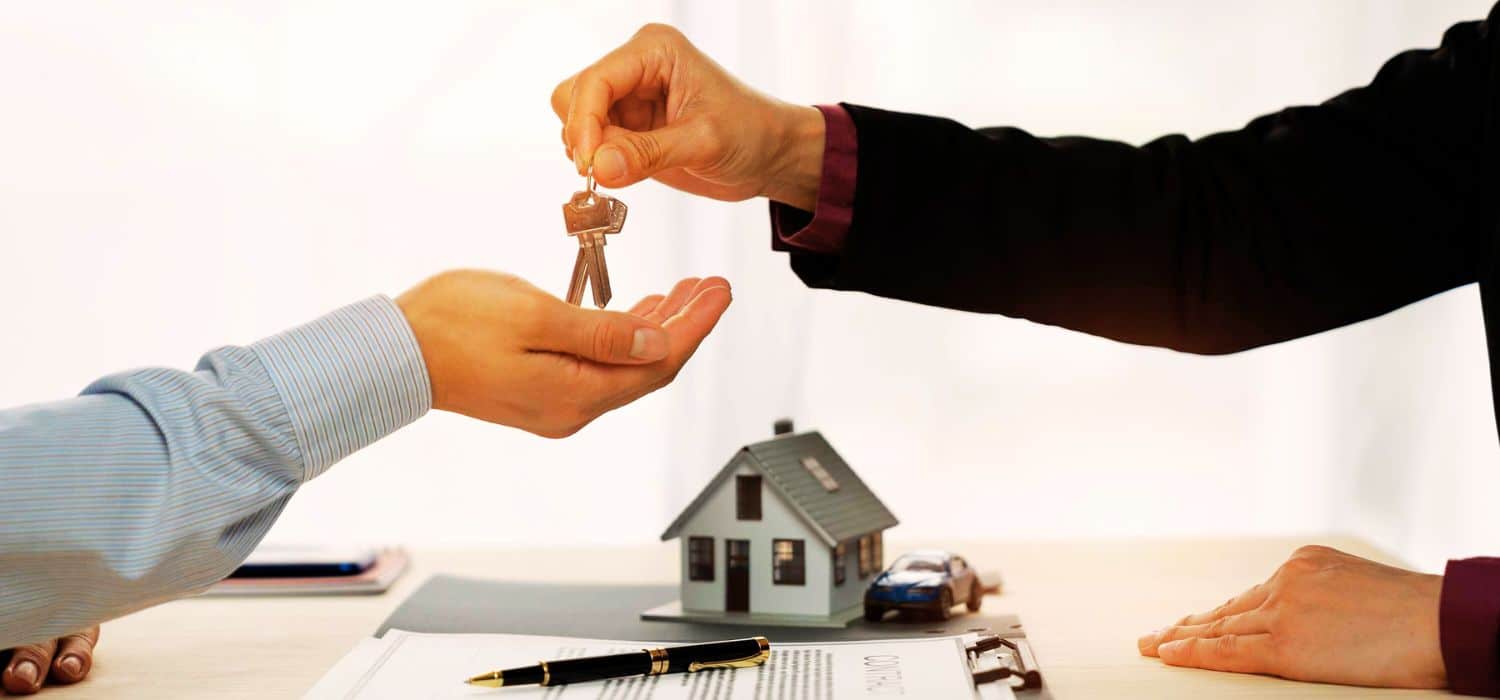 Property settlement lawyer handing keys to client